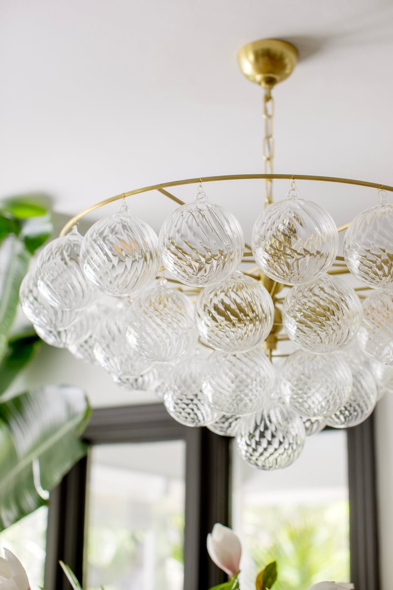Velineon Chandelier Clear Glass Globe Aged Brass Elegant