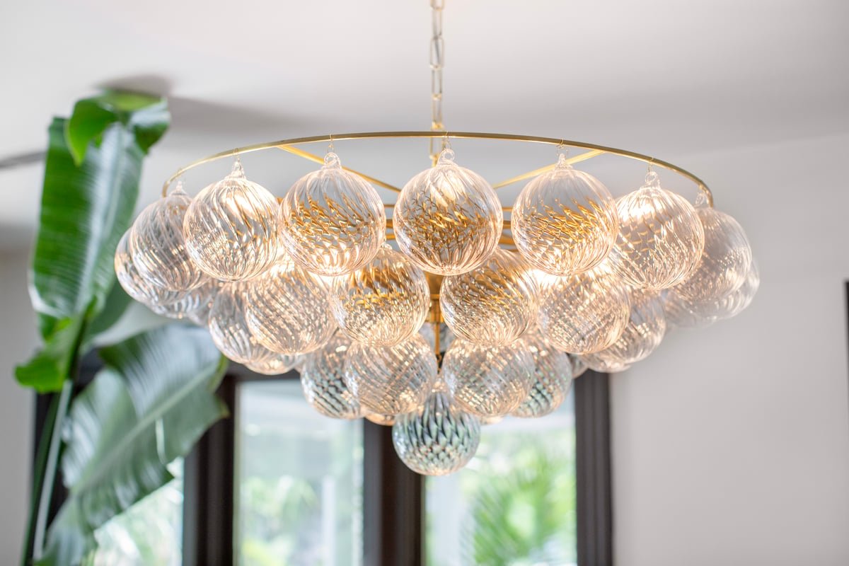 Velineon Chandelier Clear Glass Globe Aged Brass Elegant